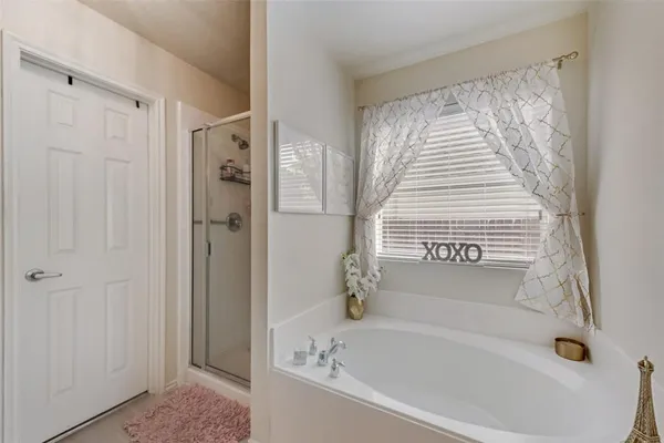 a bathroom with a bathtub and a shower