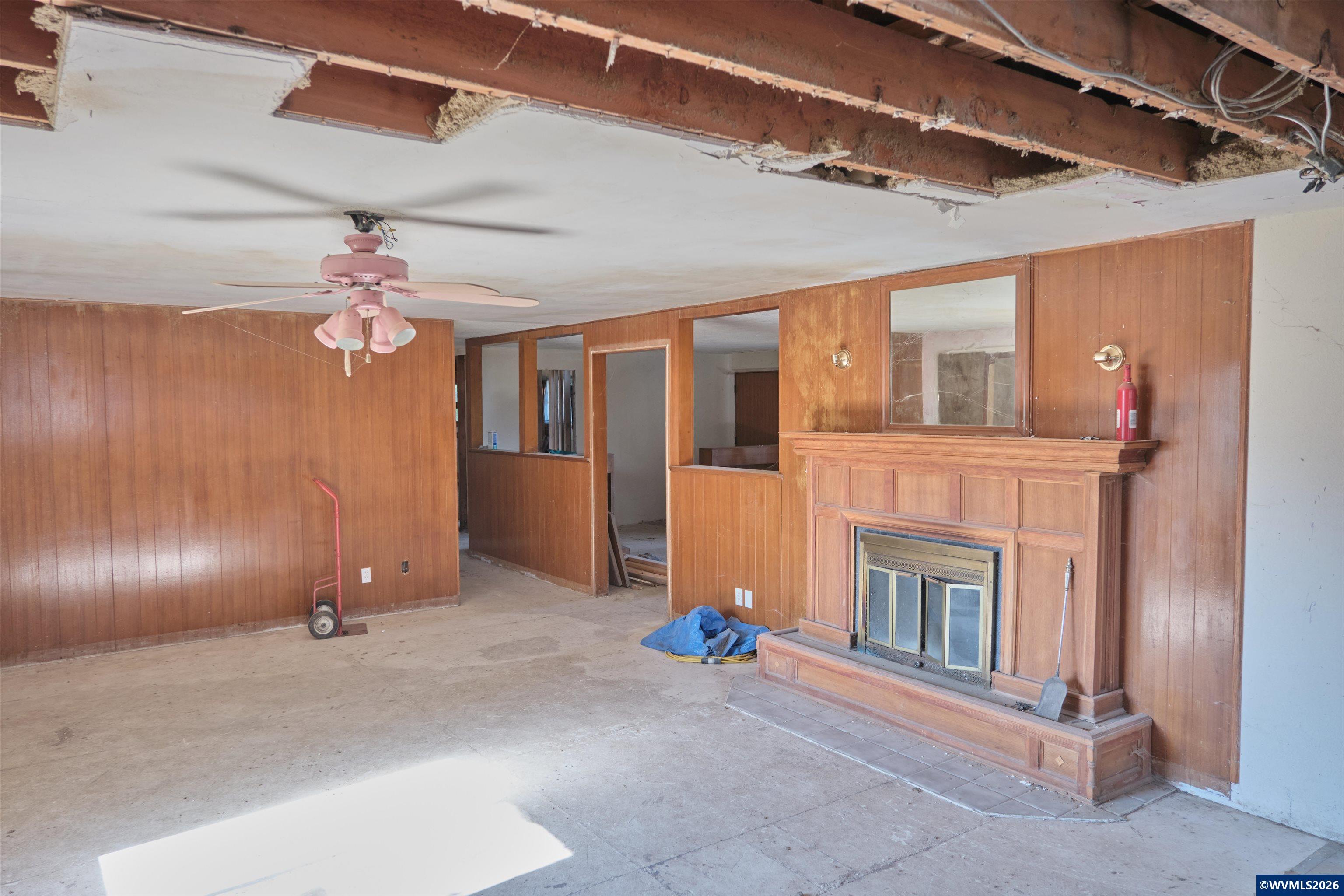 5495 Howell Prairie Road Southeast Aumsville, OR 97325 - Photo 8 of 22 a view of a livingroom with a fireplace stairs and a ceiling fan