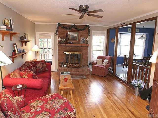 7301 St Ledger Drive Raleigh, NC 27613 - Photo 1 of 1 a living room with furniture fireplace and flat screen tv