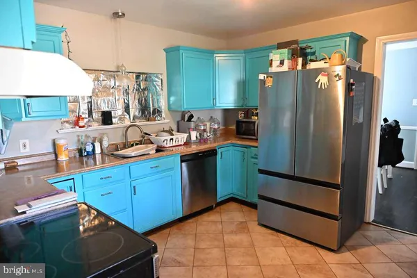 a kitchen with stainless steel appliances granite countertop a refrigerator and a stove