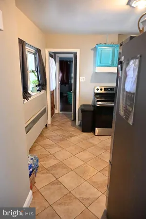 a kitchen with stainless steel appliances kitchen island granite countertop a refrigerator and a stove top oven