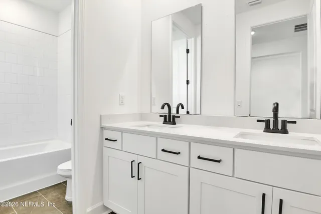 a bathroom with a sink a toilet and a bathtub