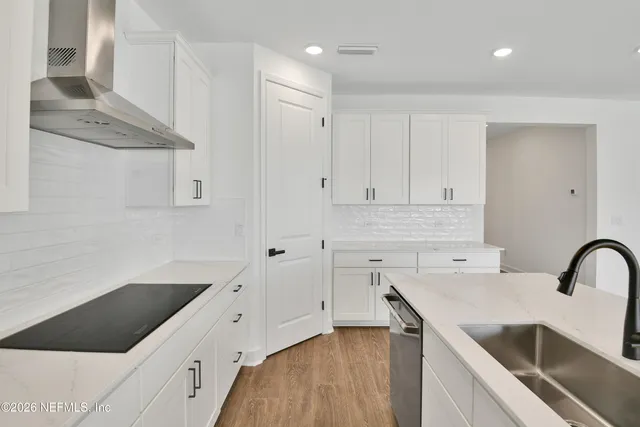 a kitchen with a sink cabinets and window