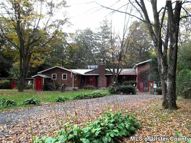 a view of a big house with a big yard and large tree