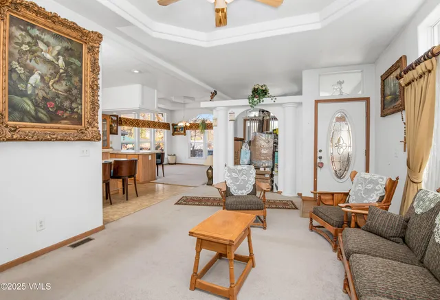 a living room with furniture and wooden floor