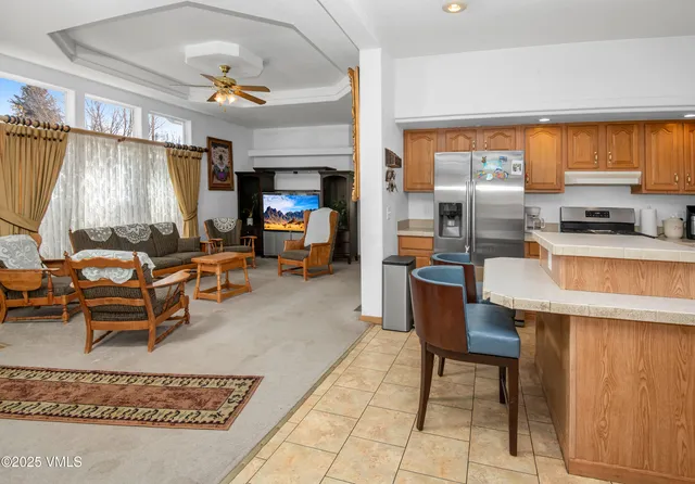 a living room filled with furniture and a large window