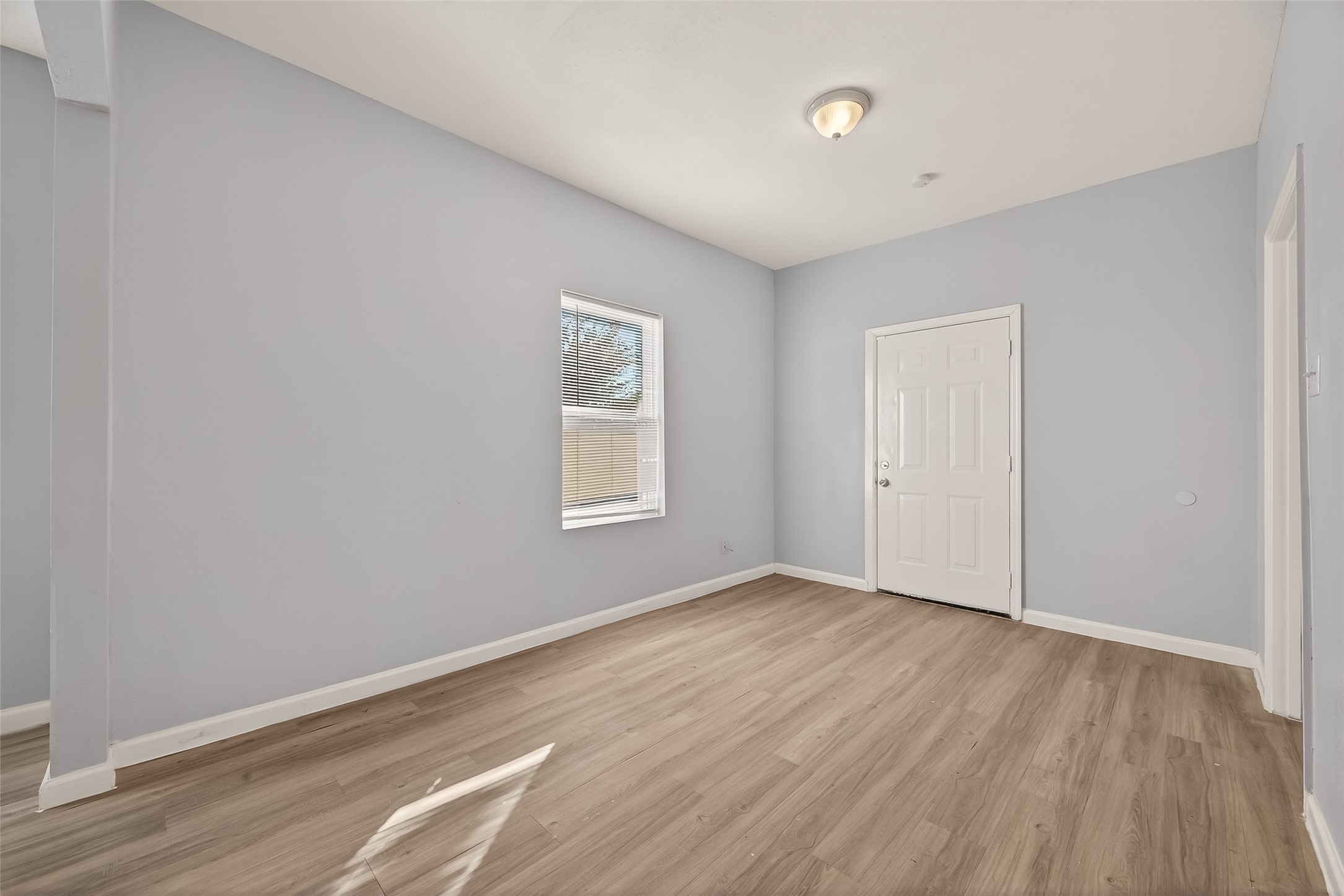 8211 Parnell Street Houston, TX 77051 - Photo 18 of 22 an empty room with wooden floor and windows