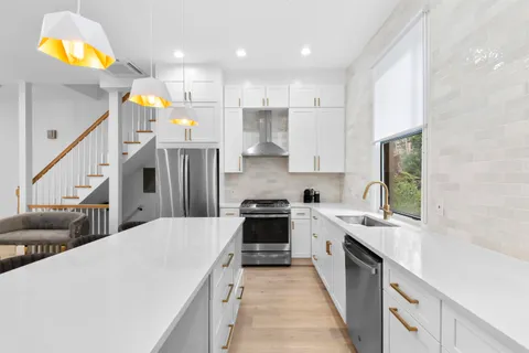 a kitchen with cabinets and a stove