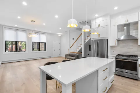a kitchen with stainless steel appliances kitchen island a large island in the center