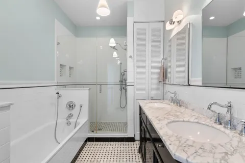 a bathroom with a granite countertop sink a shower and a mirror