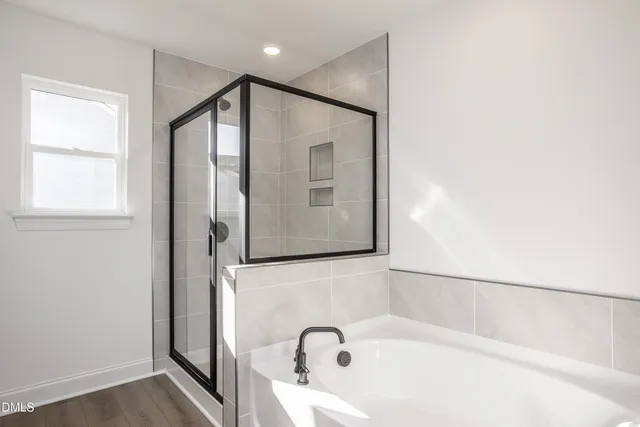 a bathroom with a bathtub and a window