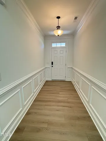 a view of a kitchen island a sink wooden floor and a living room