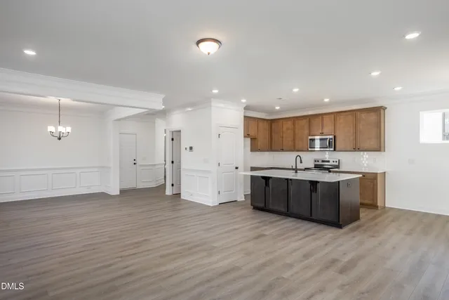 a large kitchen with a lot of counter space and stainless steel appliances