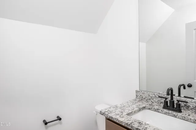 a bathroom with a granite countertop sink and vanity