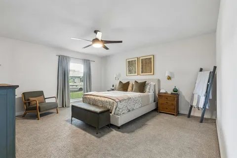 a bedroom with a bed and ceiling fan
