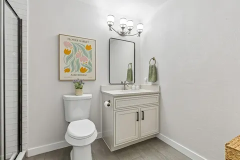 a white toilet sitting next to a bathroom sink
