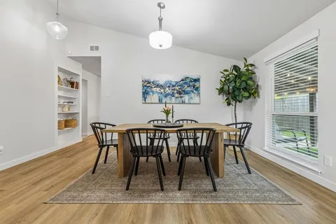 a living room with furniture and view of kitchen
