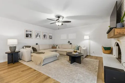 a living room with furniture and kitchen view