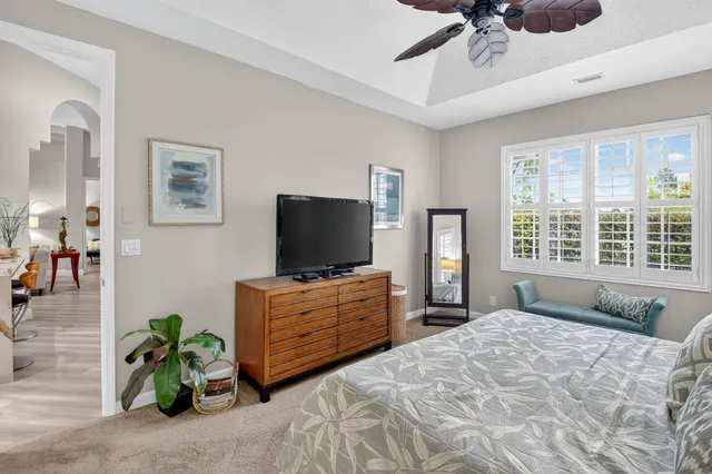 a bathroom with a granite countertop sink a toilet a mirror and bathtub
