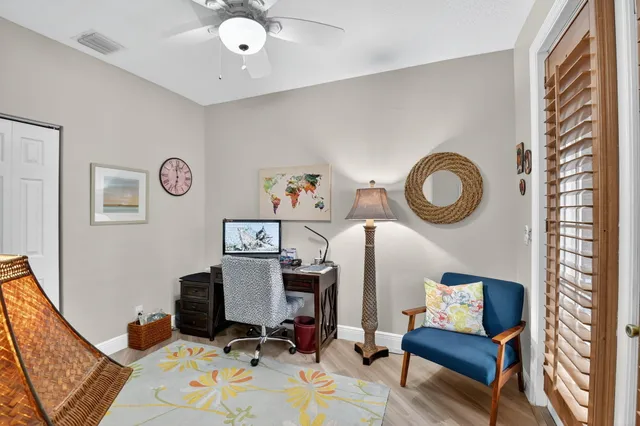 an aerial view of residential houses with outdoor space and trees
