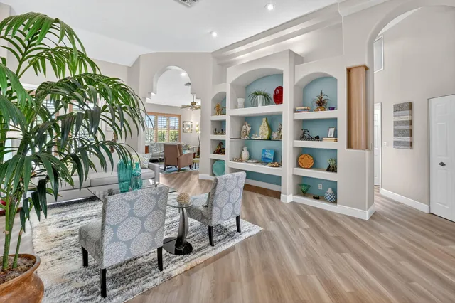 a living room with furniture and a floor to ceiling window
