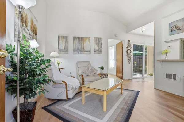 a living room with furniture and flowers