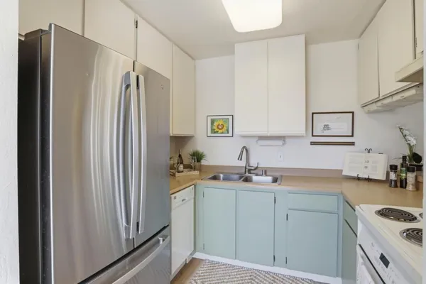 a kitchen with a stove a sink and a refrigerator