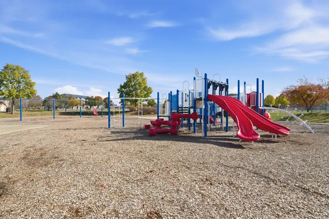 a view of outdoor space with playground and green space