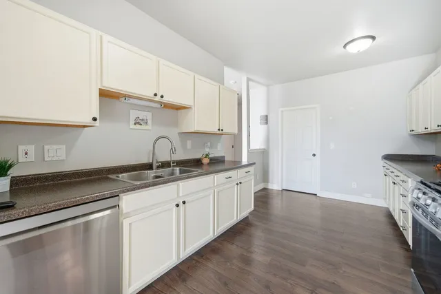 a kitchen with granite countertop a sink and cabinets