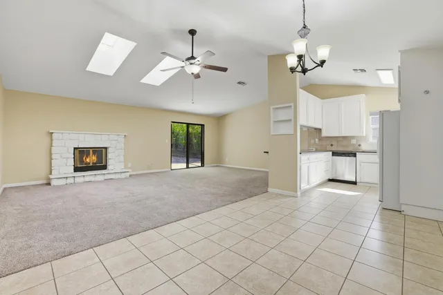 a view of a livingroom with furniture and chandelier fan