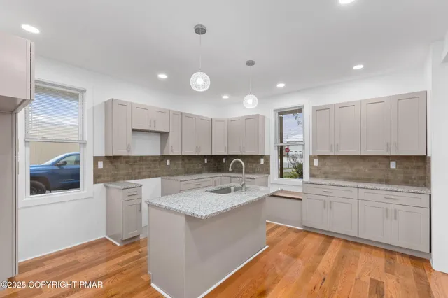 a kitchen with a sink cabinets and window