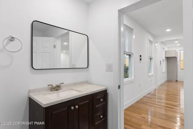 a bathroom with a sink vanity and a mirror