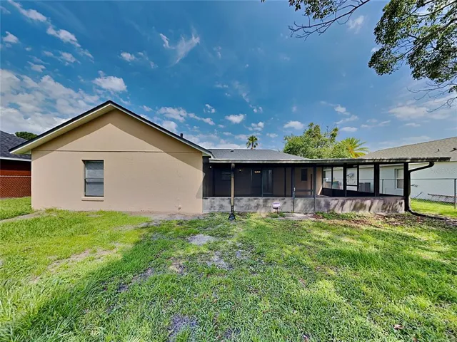 a view of a house with a yard and sitting area