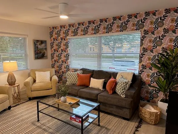 a living room with furniture and a potted plant