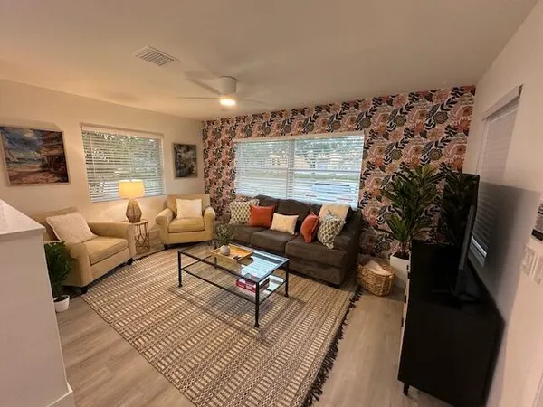 a living room with furniture and a flat screen tv