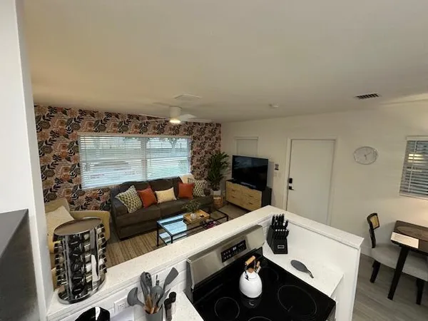 a living room with furniture and a wooden floor