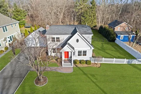 a view of house with a yard