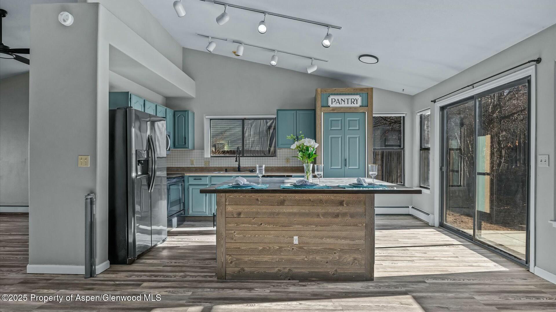 80 Juniper Lane Parachute, CO 81635 - Photo 12 of 30 a view of living room kitchen with stainless steel appliances granite countertop cabinets and fireplace