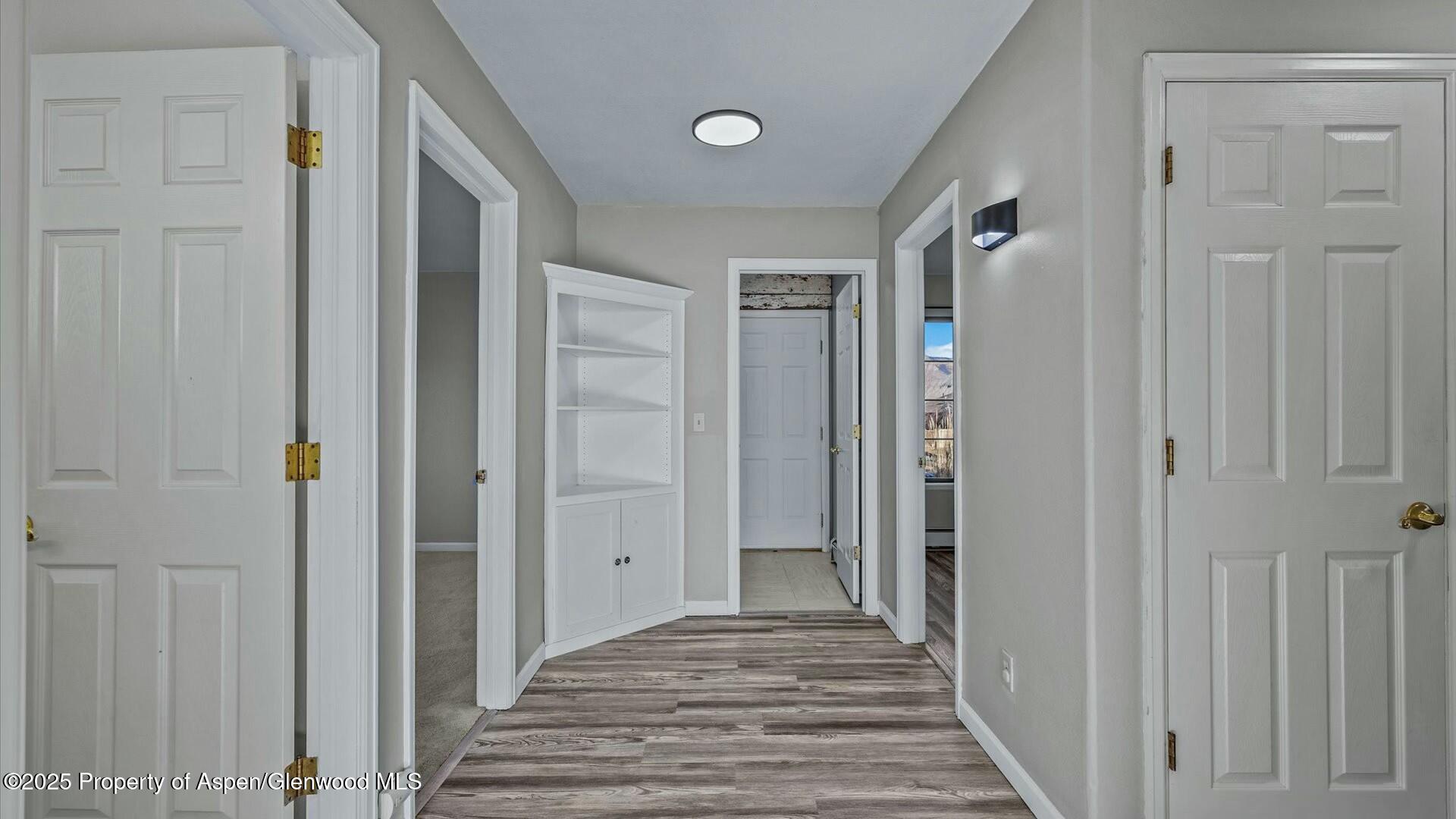 80 Juniper Lane Parachute, CO 81635 - Photo 15 of 30 a view of a hallway with wooden floor and a bathroom