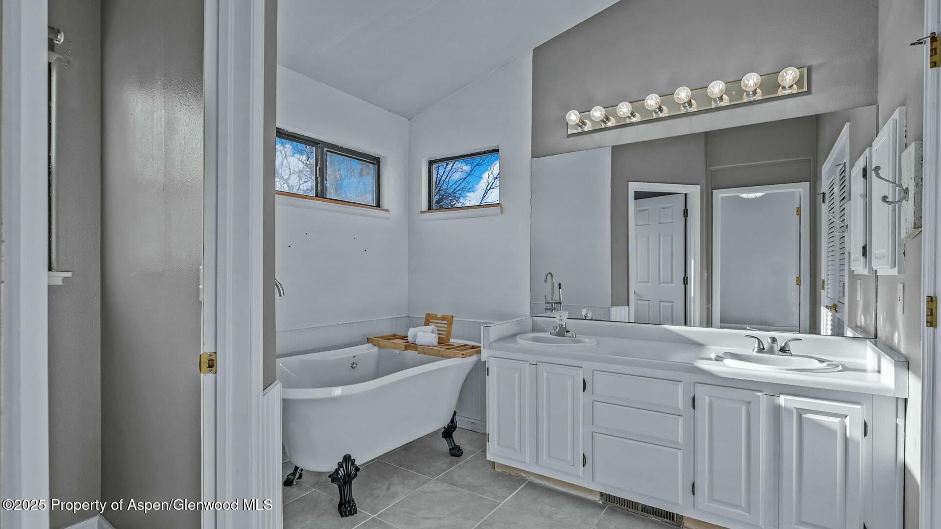 80 Juniper Lane Parachute, CO 81635 - Photo 18 of 30 a spacious bathroom with a double vanity sink and a mirror
