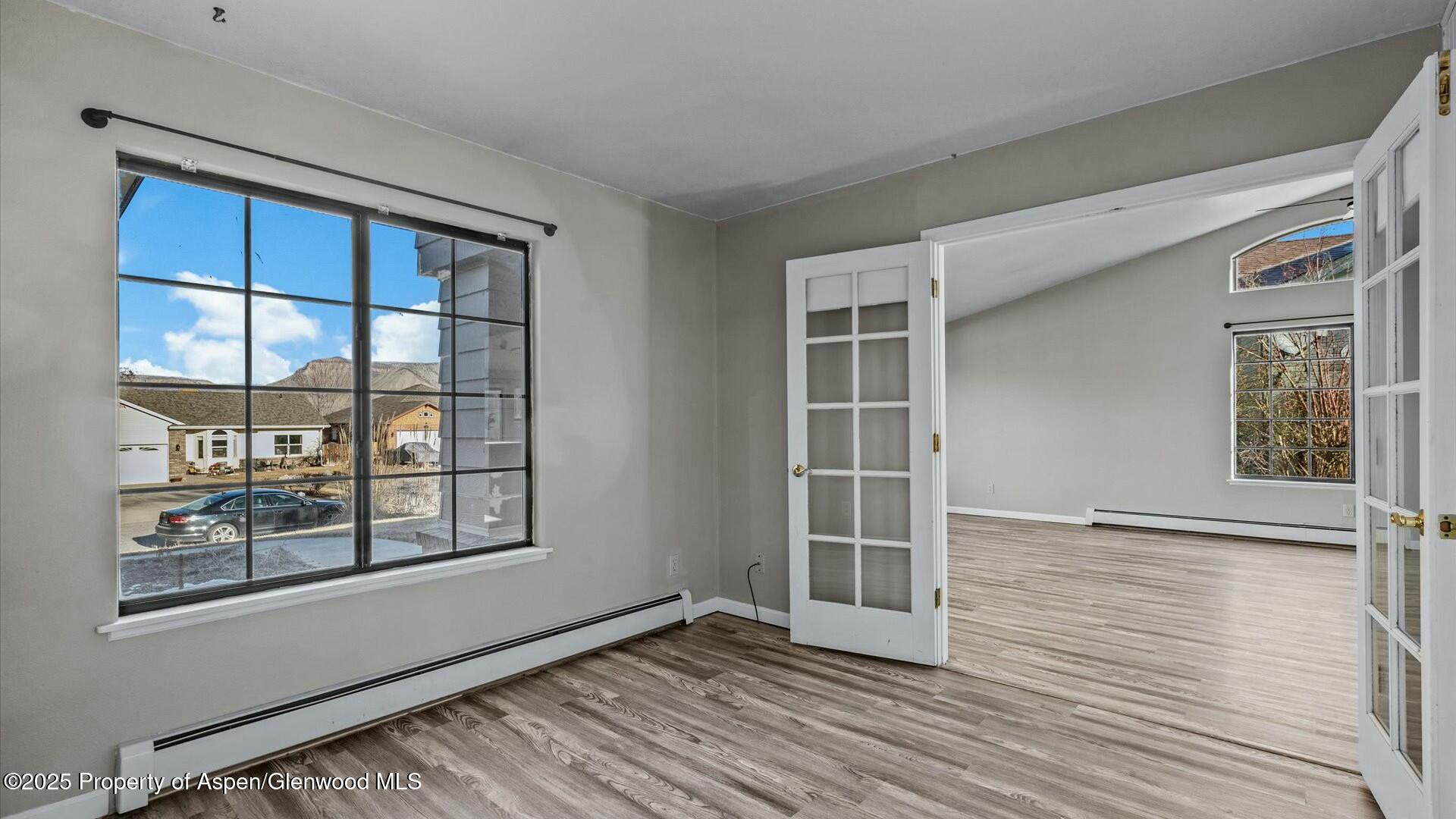 80 Juniper Lane Parachute, CO 81635 - Photo 22 of 30 a view of an empty room with wooden floor and a window
