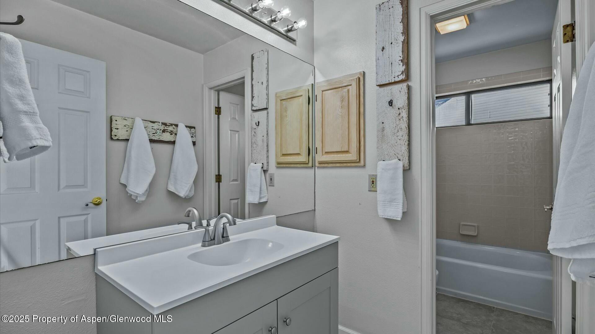 80 Juniper Lane Parachute, CO 81635 - Photo 25 of 30 a bathroom with a sink tub shower and a mirror