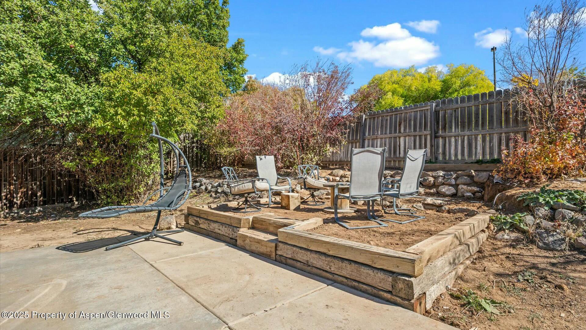 80 Juniper Lane Parachute, CO 81635 - Photo 28 of 30 a view of a patio with table and chairs and potted plants