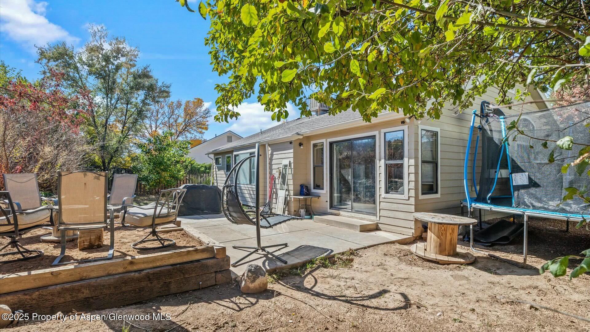 80 Juniper Lane Parachute, CO 81635 - Photo 29 of 30 a view of a patio with table and chairs and potted plants