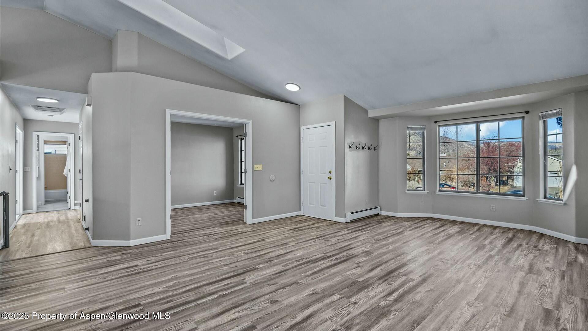 80 Juniper Lane Parachute, CO 81635 - Photo 7 of 30 a view of an empty room with wooden floor and a window