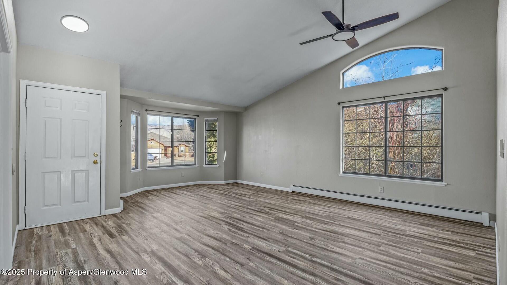 80 Juniper Lane Parachute, CO 81635 - Photo 9 of 30 an empty room with wooden floor cabinet and windows