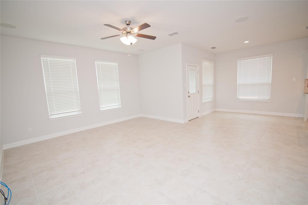 1021 Gillespie Drive Fort Worth, TX 76247 - Photo 15 of 38 an empty room with windows and fan