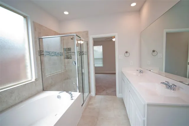 a en suite bathroom with a sink and a mirror