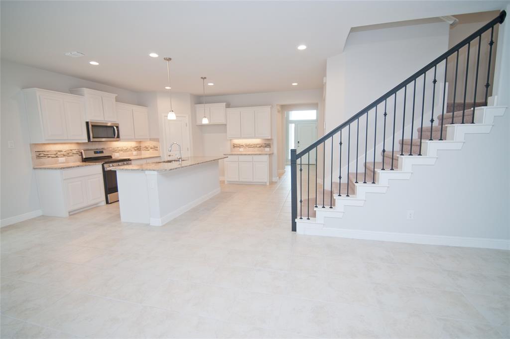 1021 Gillespie Drive Fort Worth, TX 76247 - Photo 22 of 38 a view of kitchen with sink microwave and stove