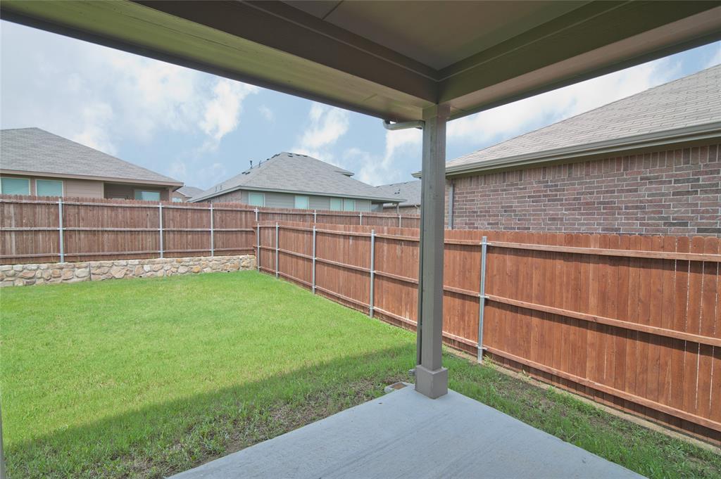 1021 Gillespie Drive Fort Worth, TX 76247 - Photo 33 of 38 a view of a backyard with a garden